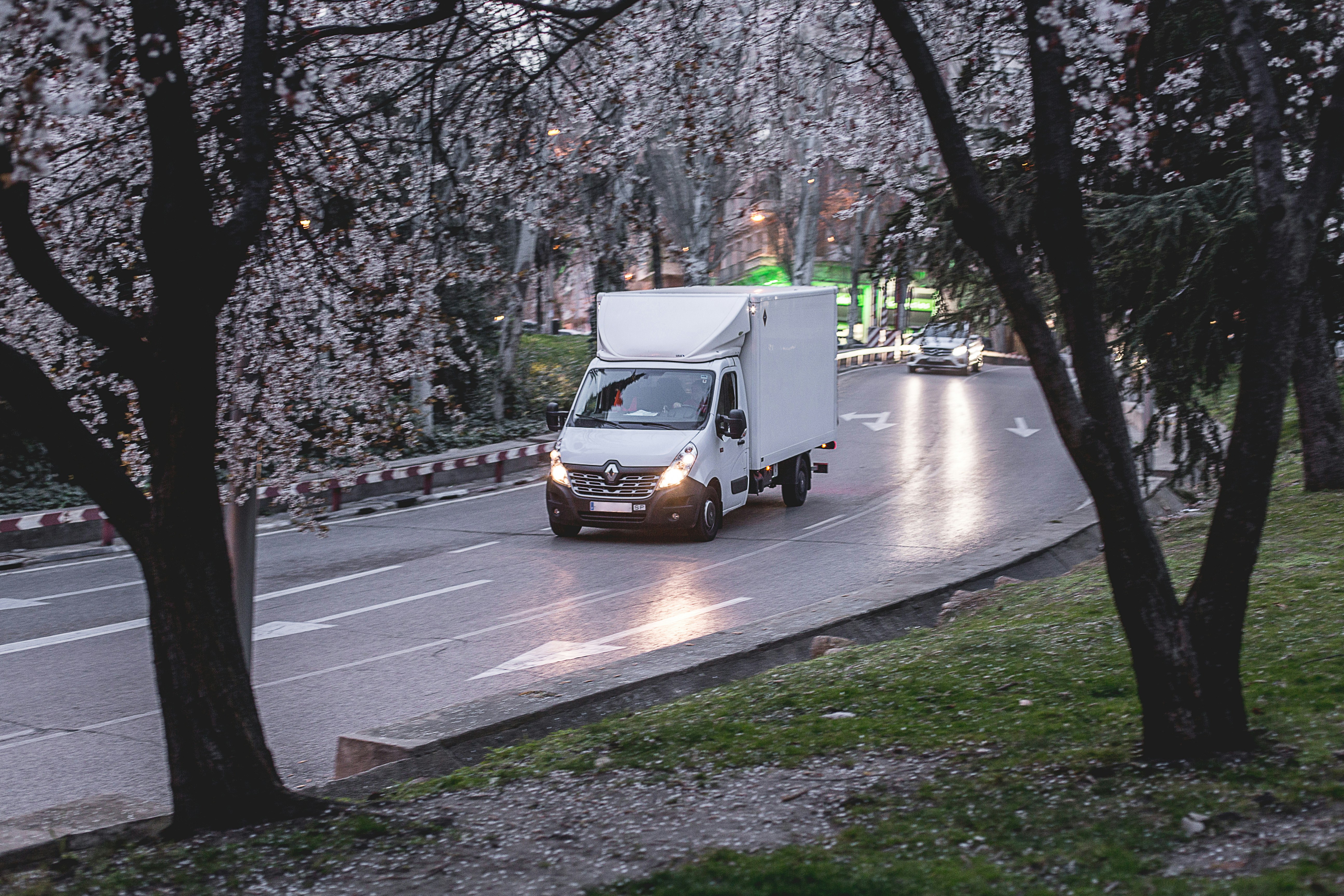 Queens Move Co. truck on the road — long distance moving service from NYC